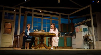 New roommates Robyn (Julia Brothers) and Sharon (Susi Damilano) discuss their families.