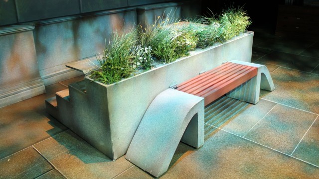 The steps of the museum rotate, revealing a garden and bench on the High Line.