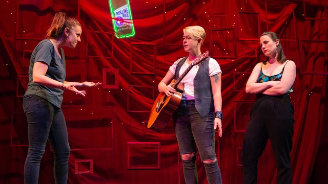 Spike (Em Lee Reaves, center) gets ready to perform as Gina (Katie Rubin) and Ani (Olivia Levine) look on.