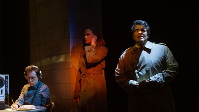 Government agents (Griffin O'Connor, Wera von Wulfen, and Christopher Reber*) report their observations back to headquarters.