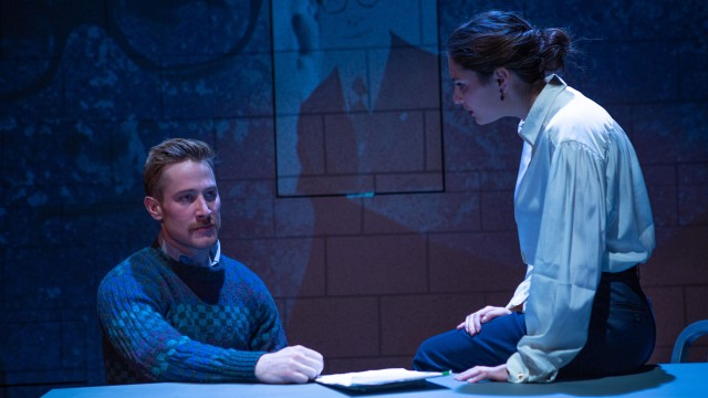 Lotte (Lauren Hart*) warns Hans (Patrick Andrew Jones*) about possible consequences.