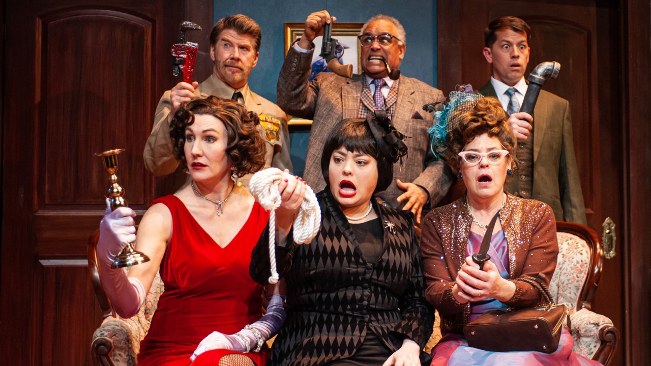 The suspects (clockwise from upper left: Michael Ray Wisely, Michael Gene Sullivan, Greg Ayers, Courtney Walsh, Renee Rogoff, and Stacy Ross) receive potential murder weapons in San Francisco Playhouse's "Clue," performing March 9 - April 22. Clue
