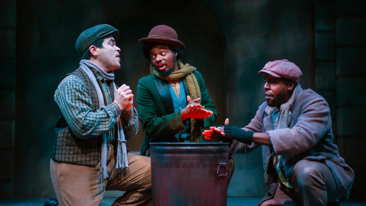 Cockney men (l to r: Julio Chavez, Kareem Jenkins, and Jurä Davis) try to keep warm in San Francisco Playhouse's "My Fair Lady," performing July 3 - September 13, 2025. Cockney men (l to r: Julio Chavez, Kareem Jenkins, and Jurä Davis) try to keep warm in San Francisco Playhouse's "My Fair Lady," performing July 3 - September 13, 2025.