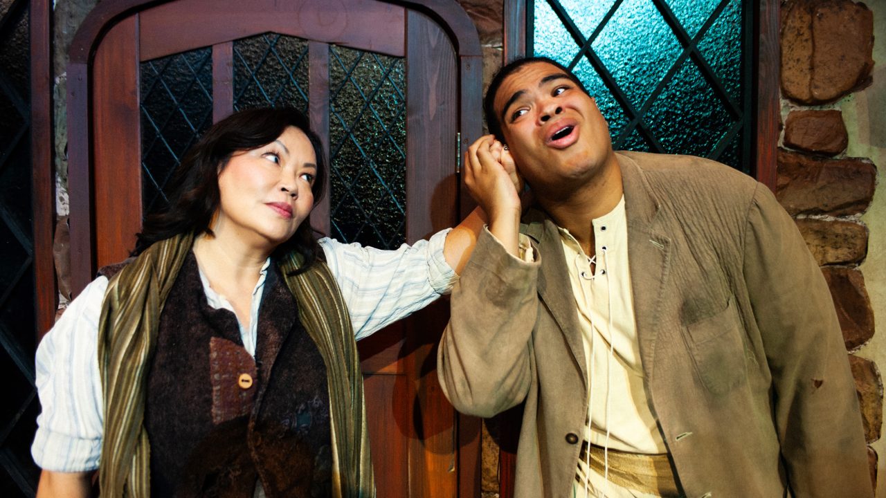 Jack's Mother (Eiko Moon-Yamamoto) scolds Jack (William I. Schmidt) in San Francisco Playhouse's "Into the Woods," performing November 20, 2025 - January 17, 2026. Jack's Mother (Eiko Moon-Yamamoto) scolds Jack (William I. Schmidt) in San Francisco Playhouse's "Into the Woods," performing November 20, 2025 - January 17, 2026.