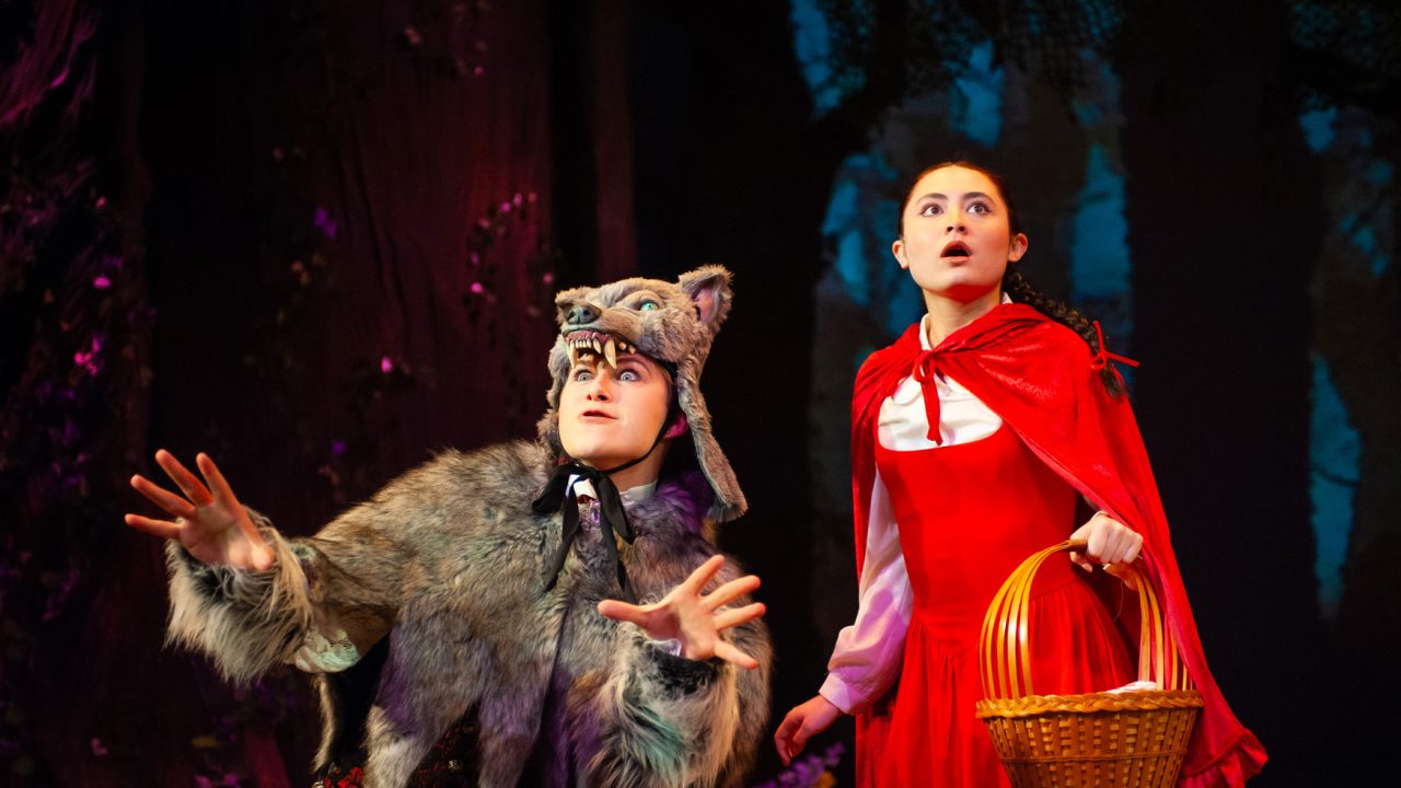 A wolf (Trevor March) appeals to Little Red Riding Hood (Olivia Hellman) in San Francisco Playhouse's "Into the Woods," performing November 20, 2025 - January 17, 2026. A wolf (Trevor March) appeals to Little Red Riding Hood (Olivia Hellman) in San Francisco Playhouse's "Into the Woods," performing November 20, 2025 - January 17, 2026.