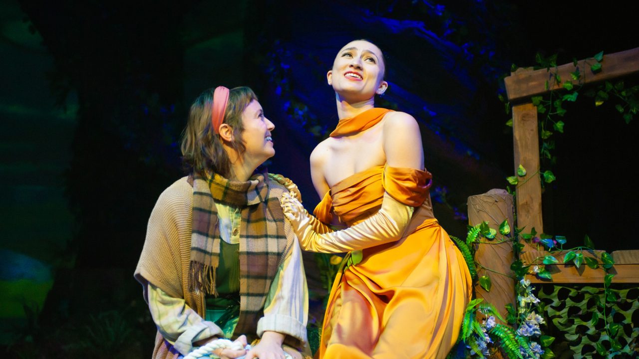 The Baker's Wife (Ruby Day) listens to Cinderella (Jillian A. Smith) in San Francisco Playhouse's "Into the Woods," performing November 20, 2025 - January 17, 2026. The Baker's Wife (Ruby Day) listens to Cinderella (Jillian A. Smith) in San Francisco Playhouse's "Into the Woods," performing November 20, 2025 - January 17, 2026.