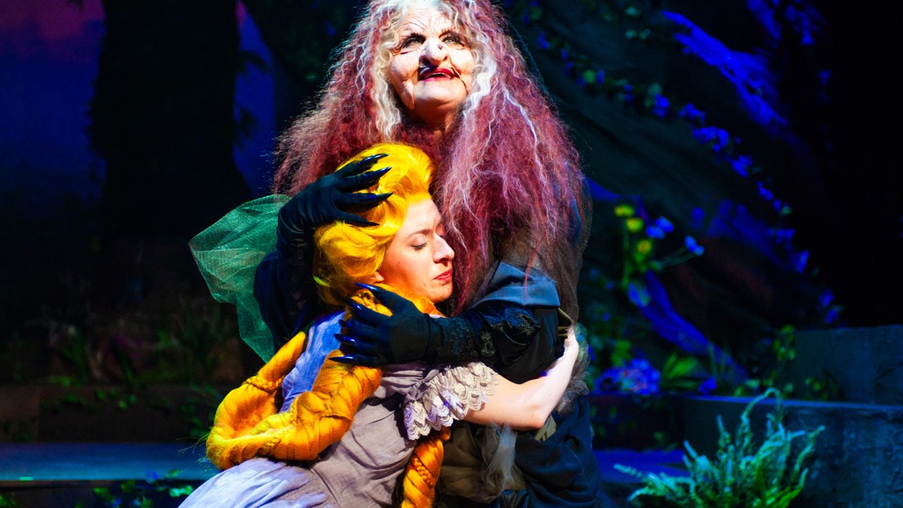 Rapunzel (Samantha Rich) is embraced by The Witch (Alison Ewing) in San Francisco Playhouse's "Into the Woods," performing November 20, 2025 - January 17, 2026. Rapunzel (Samantha Rich) is embraced by The Witch (Alison Ewing) in San Francisco Playhouse's "Into the Woods," performing November 20, 2025 - January 17, 2026.